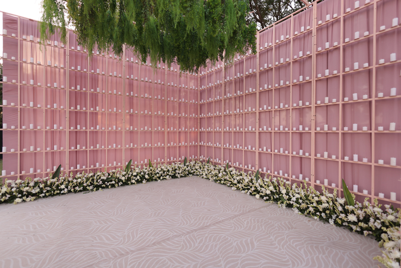 Long dining tables under rows of candles and chandeliers
