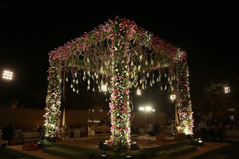 Long dining tables under rows of candles and chandeliers