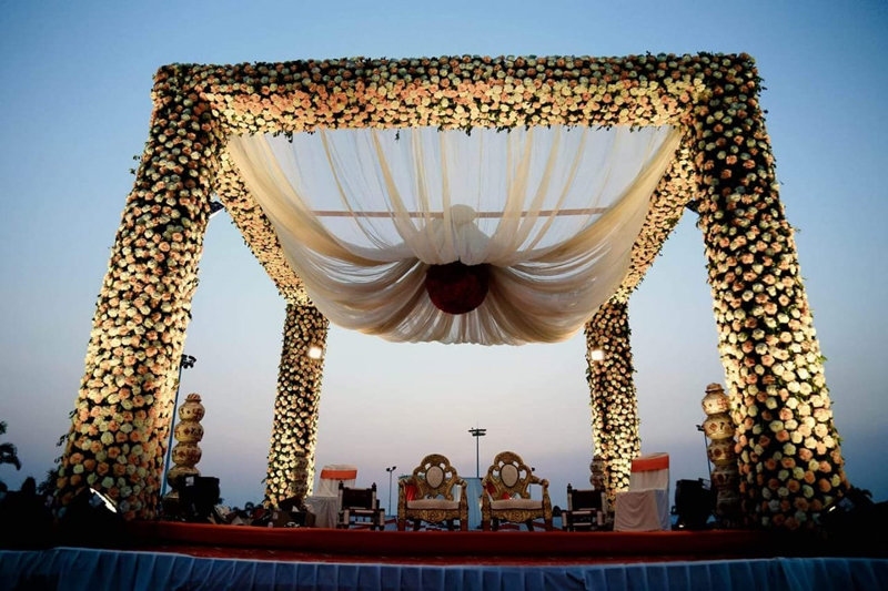 Long dining tables under rows of candles and chandeliers