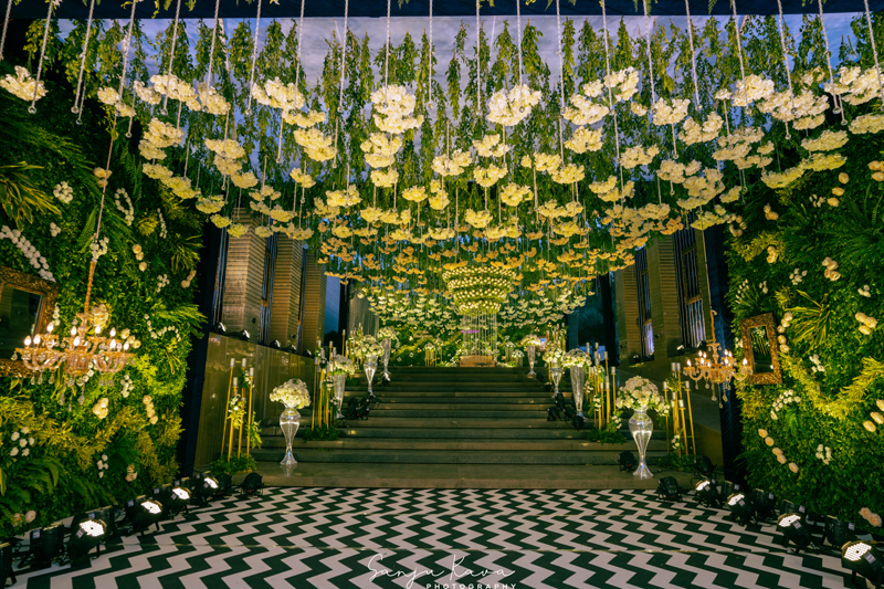 Long dining tables under rows of candles and chandeliers